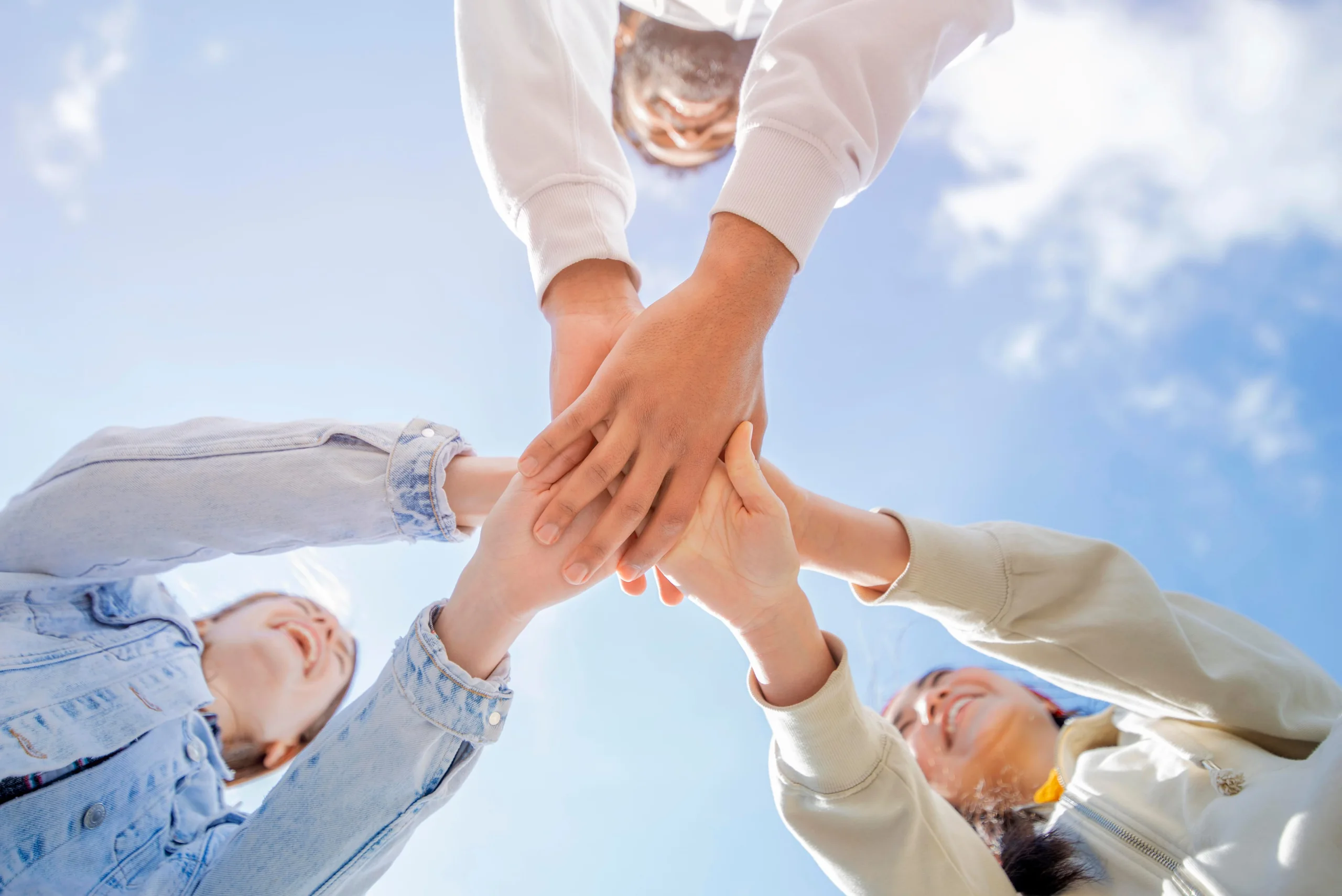 Team joining hands in collaboration